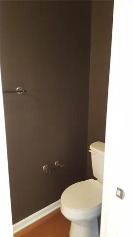 a white toilet sitting next to a bathroom sink