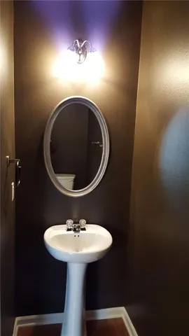 a bathroom with a sink toilet and mirror