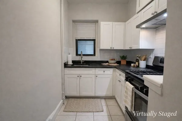 a kitchen with a sink and cabinets