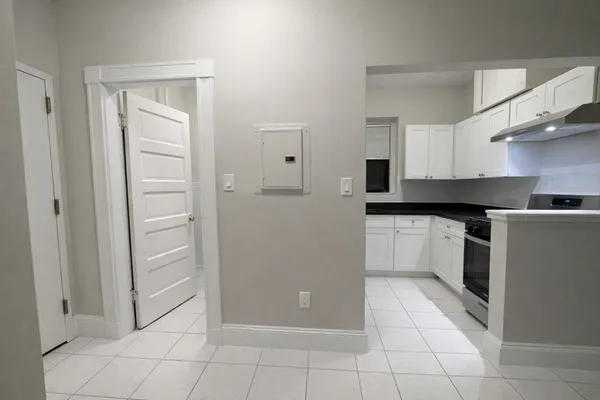 a kitchen with white cabinets and white appliances