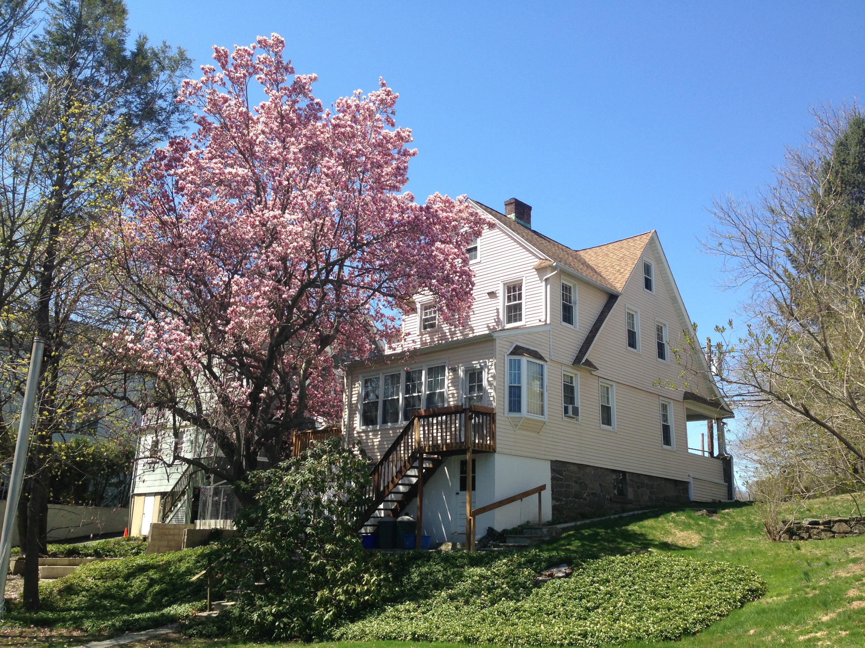 191 Field Point Road Greenwich, CT 06830 - Photo 2 of 2 front view of a house with a tree