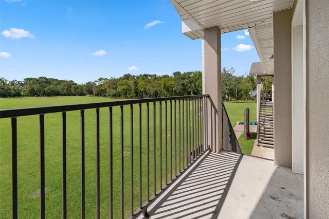 a view of balcony with wooden floor and fence