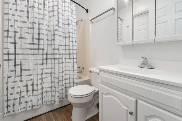 a bathroom with a white toilet and sink