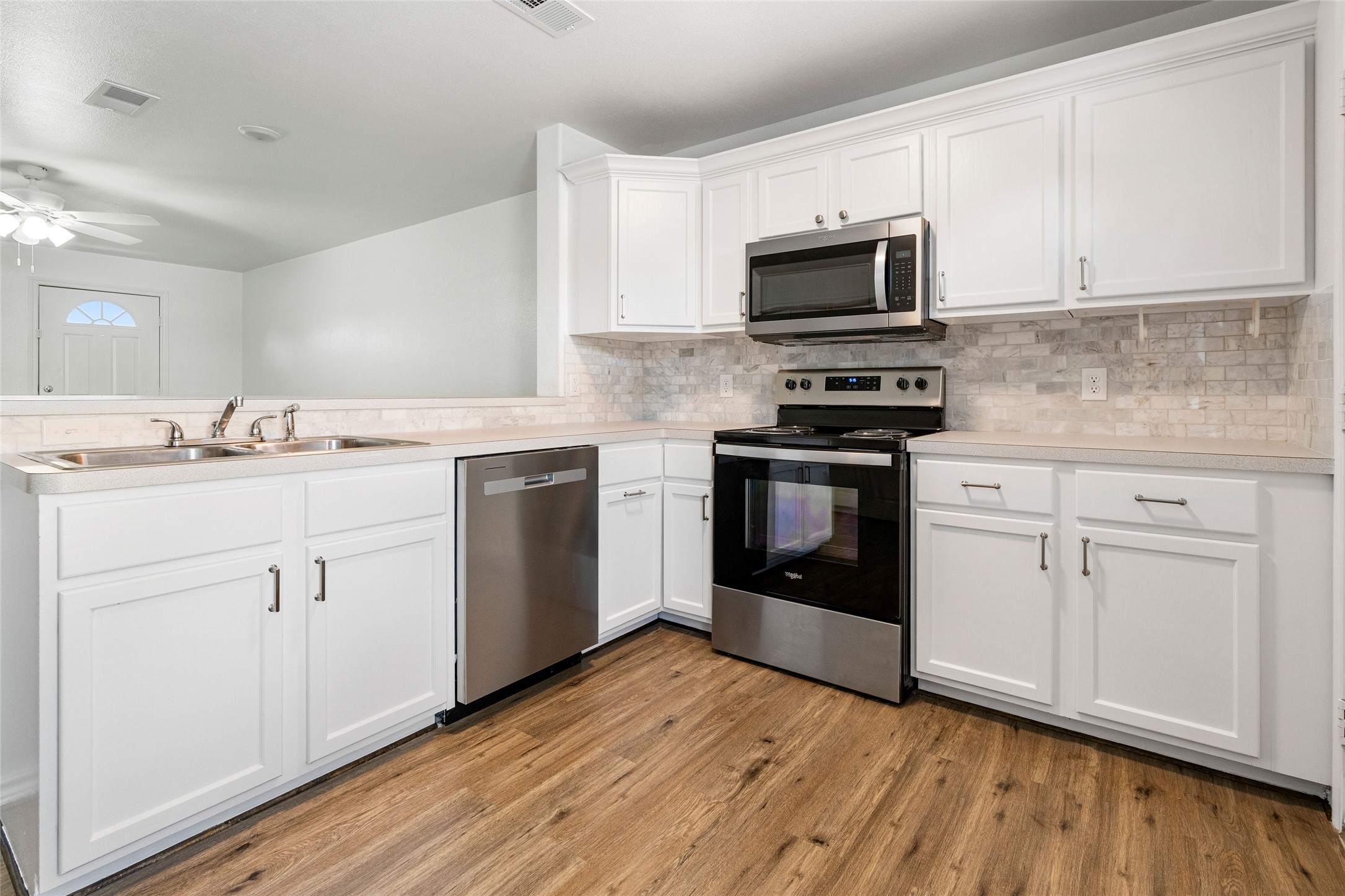 210 Brazos Street, Unit 202 Brazoria, TX 77422 - Photo 10 of 20 a kitchen with a sink stove and cabinets