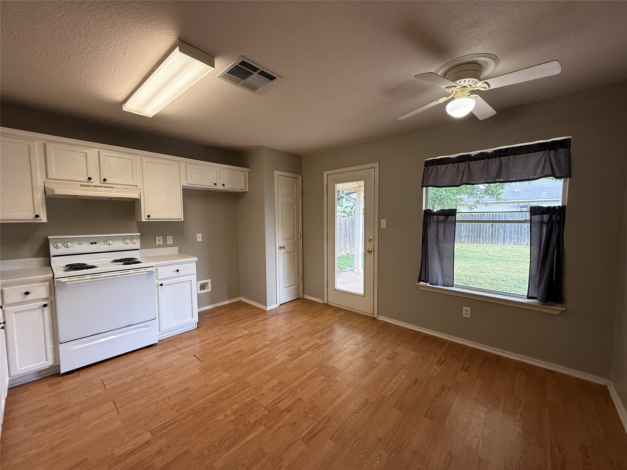 2120 Jester Farms Road Round Rock, TX 78664 - Photo 9 of 28 A well-equipped kitchen offers ample cabinetry and direct access to the private yard.