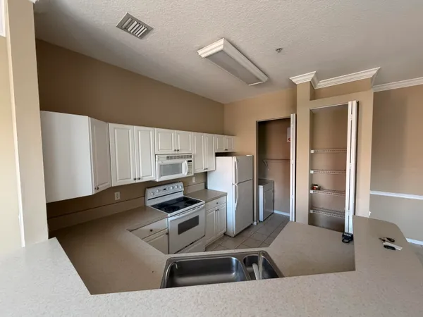 a kitchen that has a sink and a stove in it