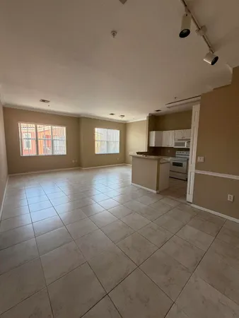 a large kitchen with white cabinets and stainless steel appliances