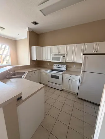 a kitchen with a stove a sink and a refrigerator