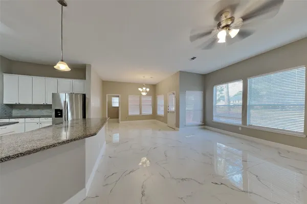 a view of a kitchen with granite countertop a sink a stove a refrigerator and a granite counter tops
