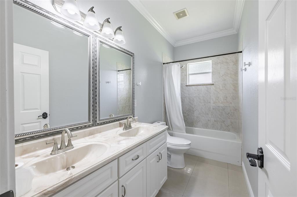2323 West Cherry Street Tampa, FL 33607 - Photo 13 of 20 a bathroom with a double vanity sink mirror double and toilet