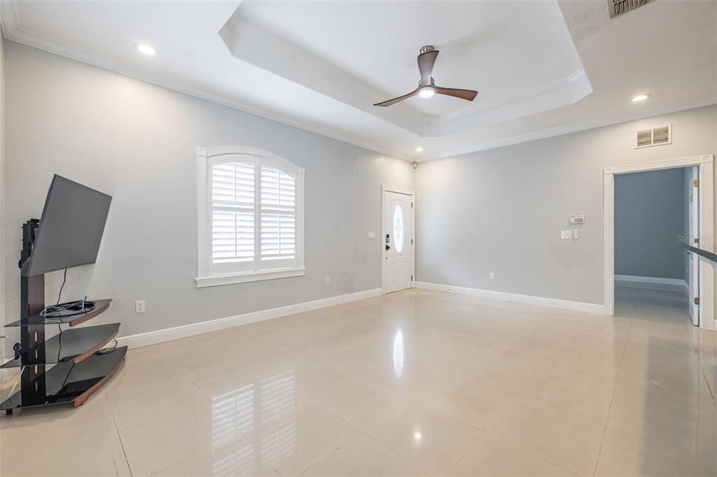 2323 West Cherry Street Tampa, FL 33607 - Photo 6 of 20 a view of an empty room with a window and a ceiling fan