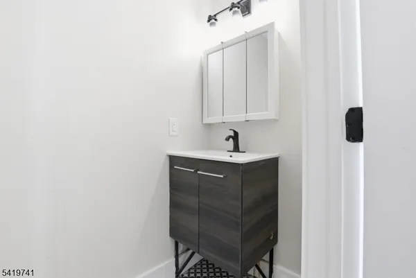 a bathroom with a sink and mirror