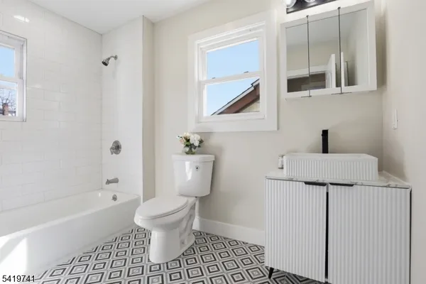 a bathroom with a toilet a sink and bathtub