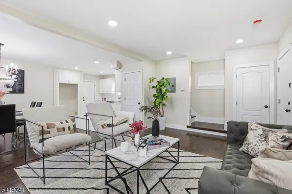 a living room with furniture and flowers