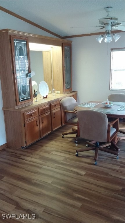 a room with a table chair and windows