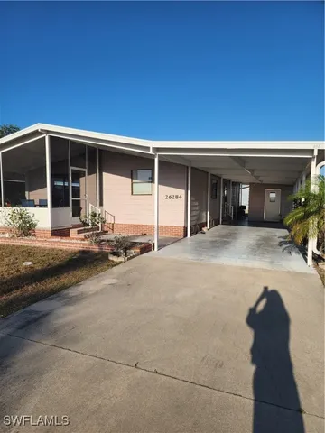 a front view of a house with yard outdoor seating and garage