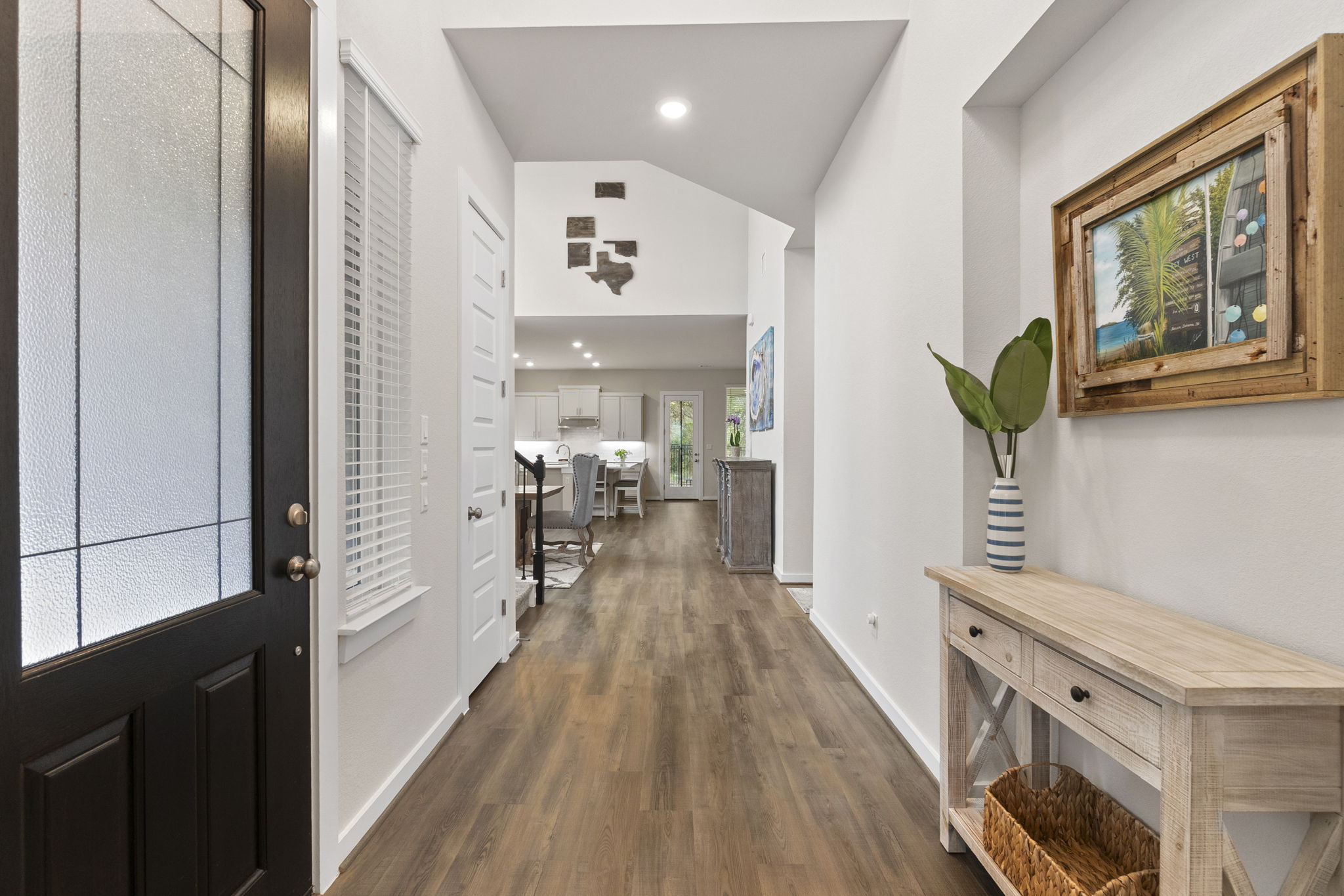460 Constitution Way Kyle, TX 78640 - Photo 6 of 40 Entryway featuring wood-finish flooring, a black paneled door with decorative glass, white walls, recessed lighting, and an open concept layout