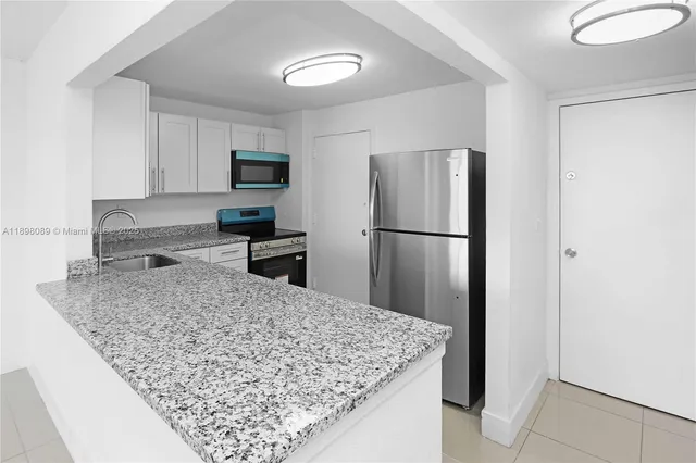 a kitchen with stainless steel appliances granite countertop a stove microwave and sink