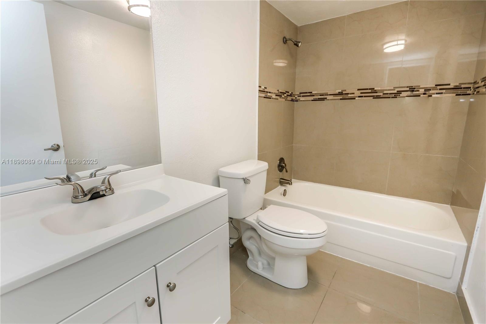 9001 Southwest 77th Avenue, Unit C803 Miami, FL 33156 - Photo 15 of 20 a bathroom with a sink a toilet and tub