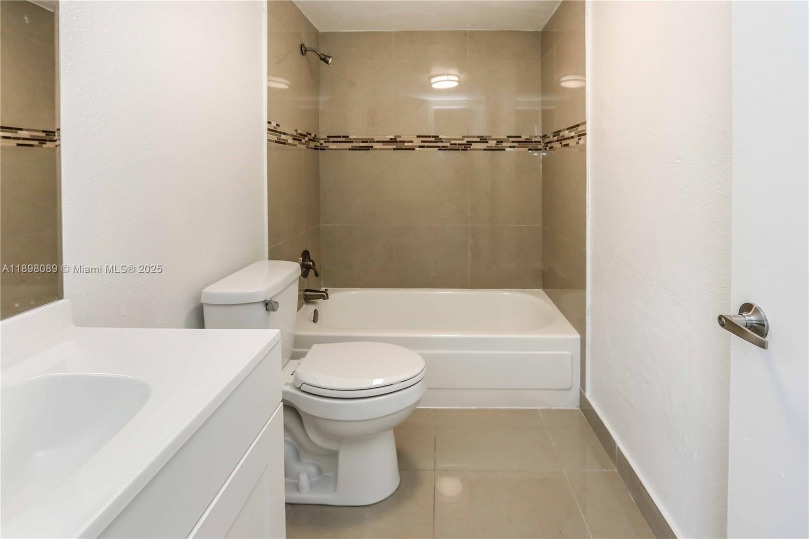 9001 Southwest 77th Avenue, Unit C803 Miami, FL 33156 - Photo 16 of 20 a bathroom with a bathtub and shower