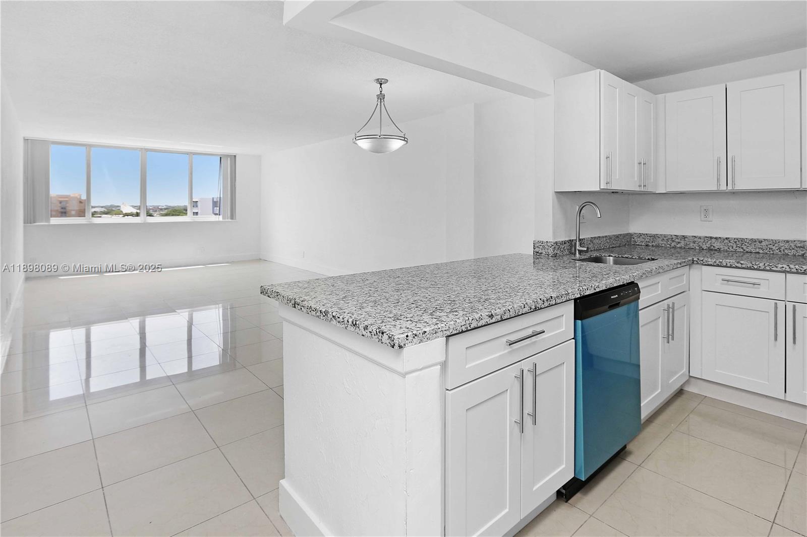 9001 Southwest 77th Avenue, Unit C803 Miami, FL 33156 - Photo 2 of 20 a kitchen with granite countertop white cabinets white appliances a sink and dishwasher