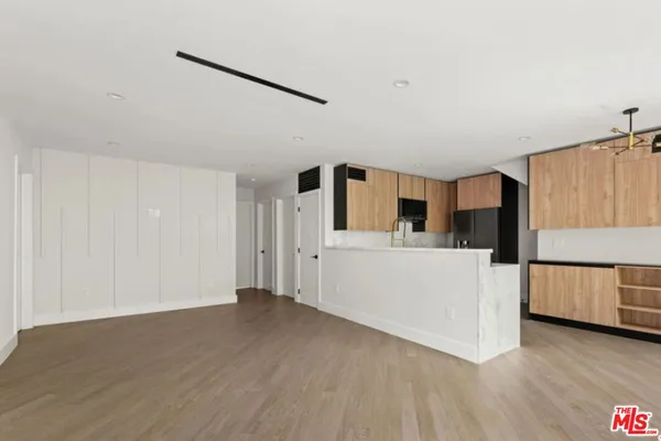 a view of a room with wooden floor and cabinet