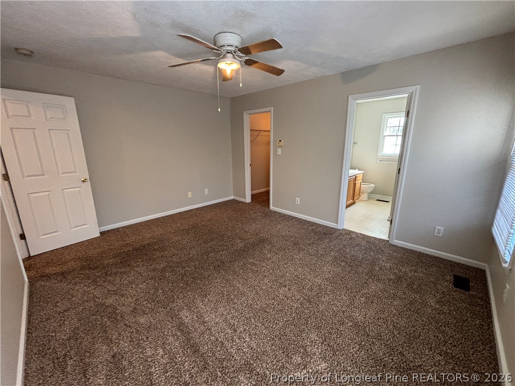 543 Killeen Road Fayetteville, NC 28303 - Photo 15 of 29 an empty room with chandelier fan and windows
