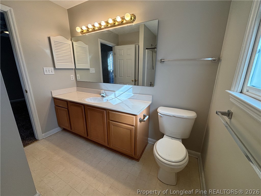 543 Killeen Road Fayetteville, NC 28303 - Photo 17 of 29 a bathroom with a toilet sink and mirror