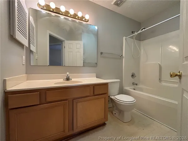 a bathroom with a sink toilet a mirror and shower