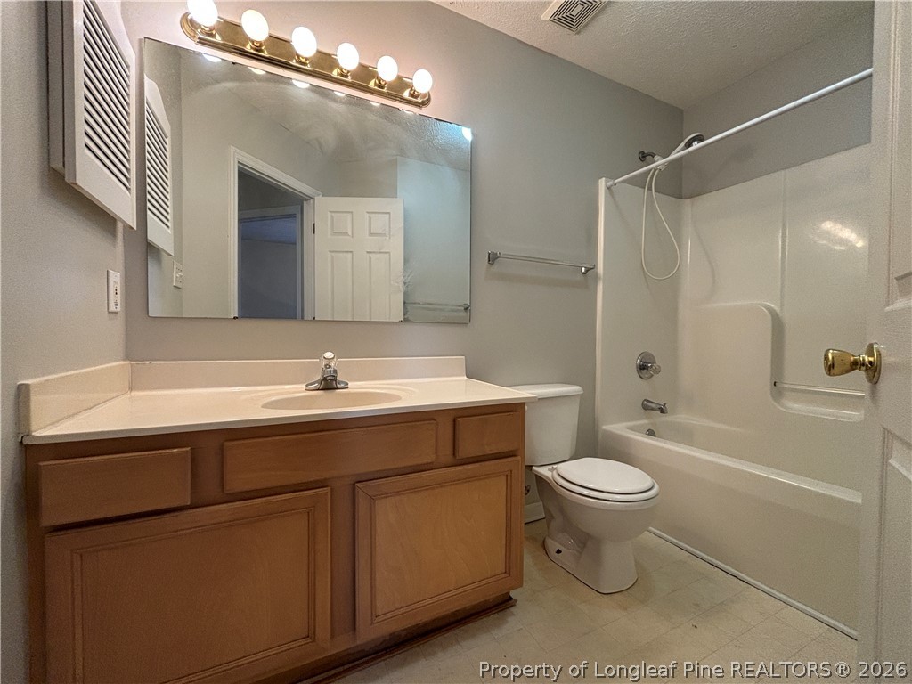 543 Killeen Road Fayetteville, NC 28303 - Photo 22 of 29 a bathroom with a sink toilet a mirror and shower