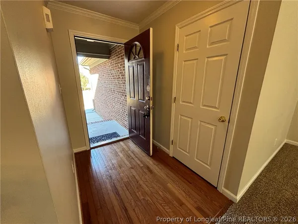 a view of front door with wooden floor