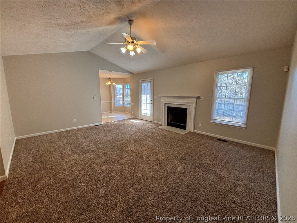 543 Killeen Road Fayetteville, NC 28303 - Photo 7 of 29 a view of an empty room with chandelier and fireplace