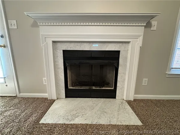 a view of empty room with a fireplace