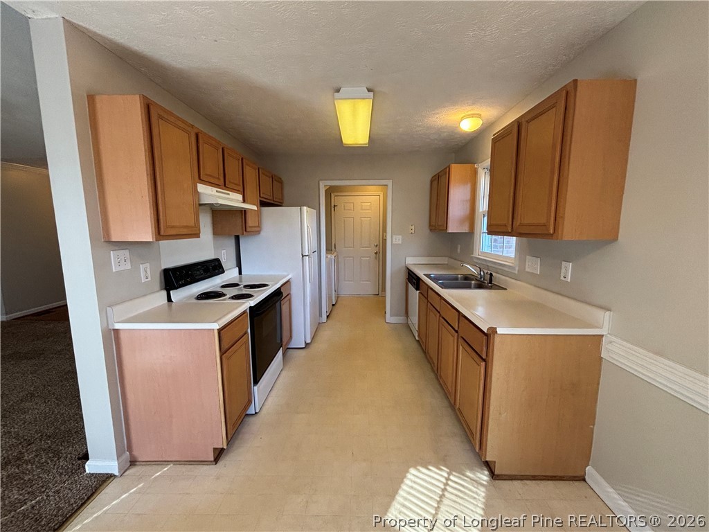 543 Killeen Road Fayetteville, NC 28303 - Photo 9 of 29 a kitchen with stainless steel appliances granite countertop a stove a sink a refrigerator and a microwave