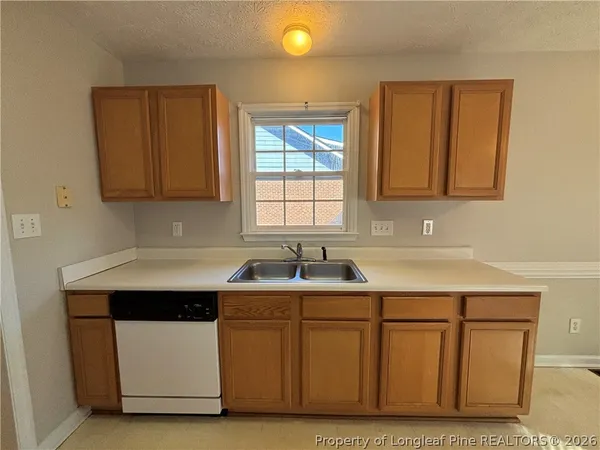 a kitchen with a sink cabinets and window