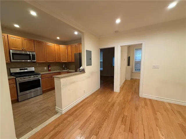 a kitchen with granite countertop a stove top oven and cabinets