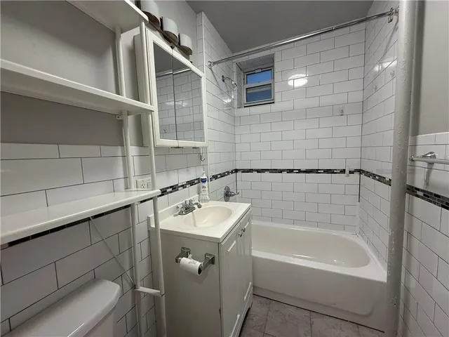 a bathroom with a bathtub and shower