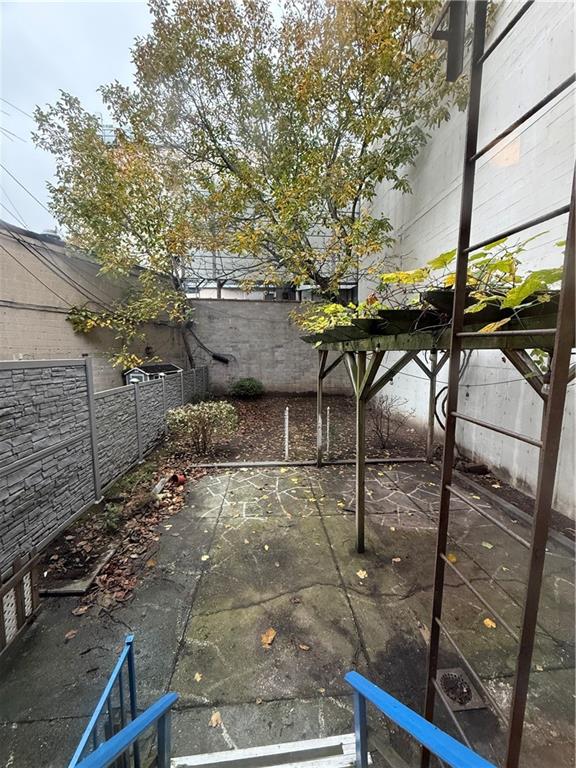 413 88th Street Brooklyn, NY 11209 - Photo 6 of 7 a backyard of a house with table and chairs