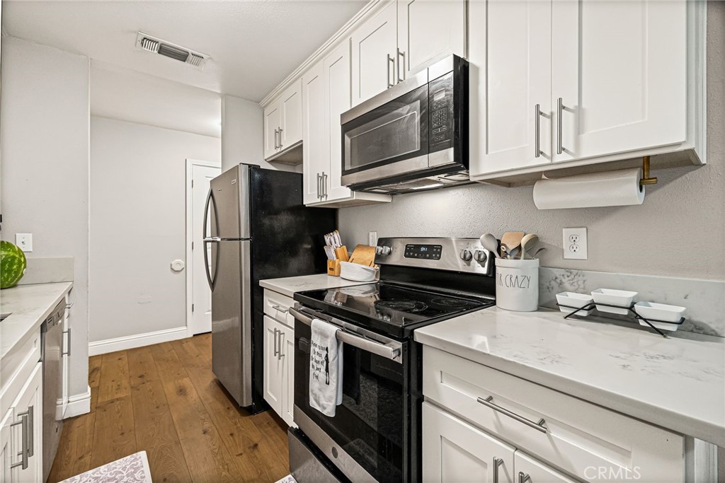 1395 Nord Avenue Chico, CA 95926 - Photo 12 of 26 a kitchen with stainless steel appliances granite countertop a refrigerator stove and microwave