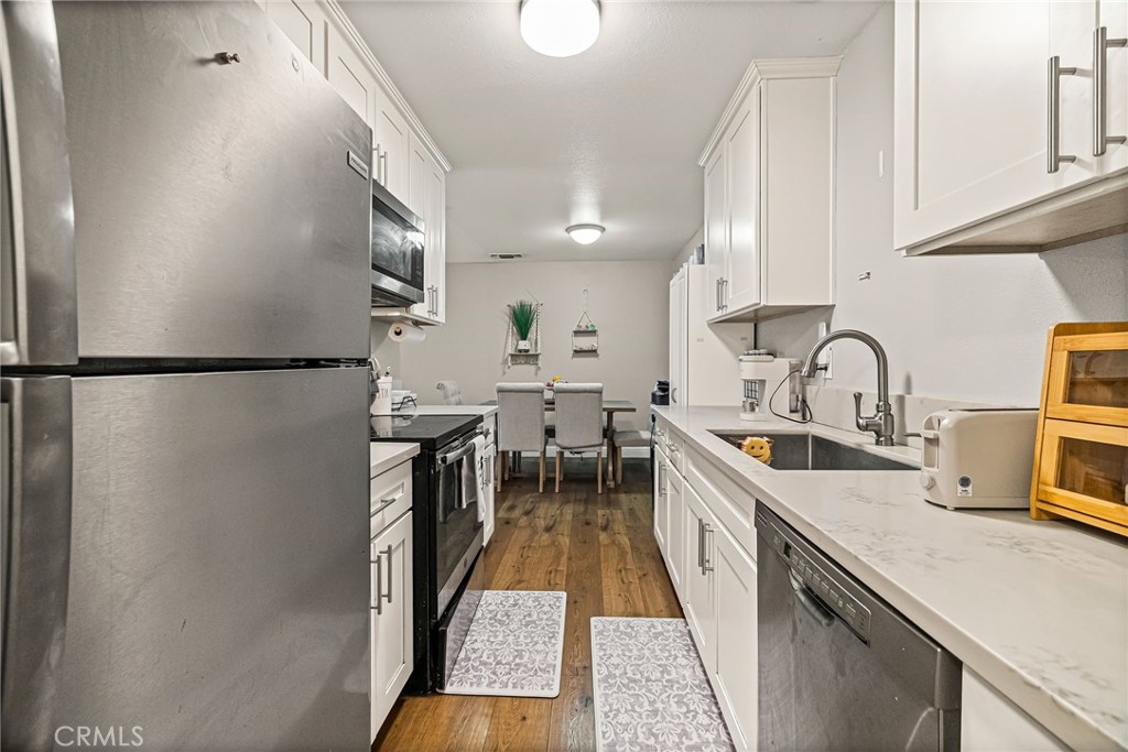 1395 Nord Avenue Chico, CA 95926 - Photo 14 of 26 a kitchen with sink a refrigerator and cabinets