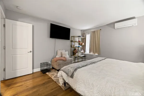 a bedroom with a bed and a flat screen tv