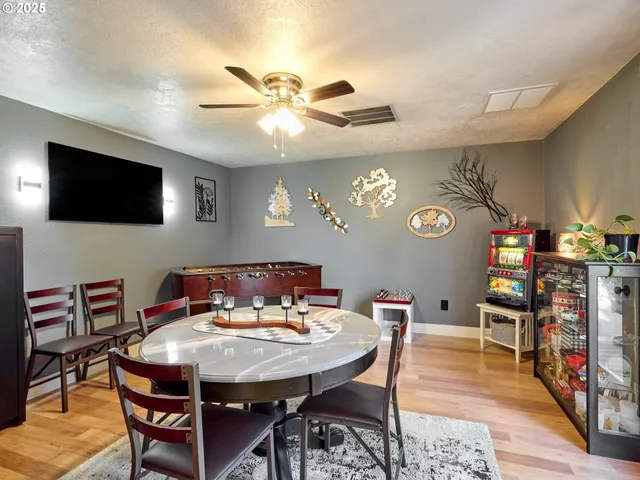 a view of a dining room with furniture and a flat screen tv