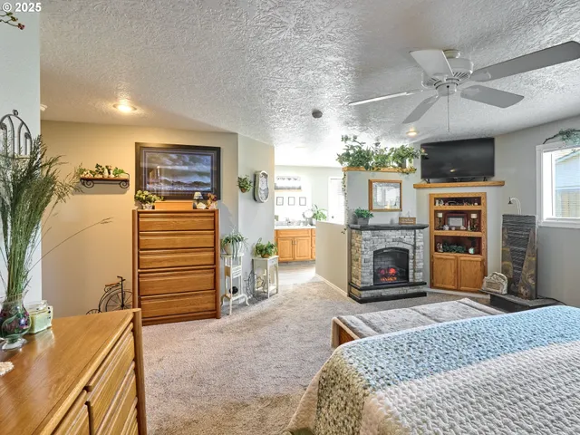 a living room with furniture a fireplace and a flat screen tv