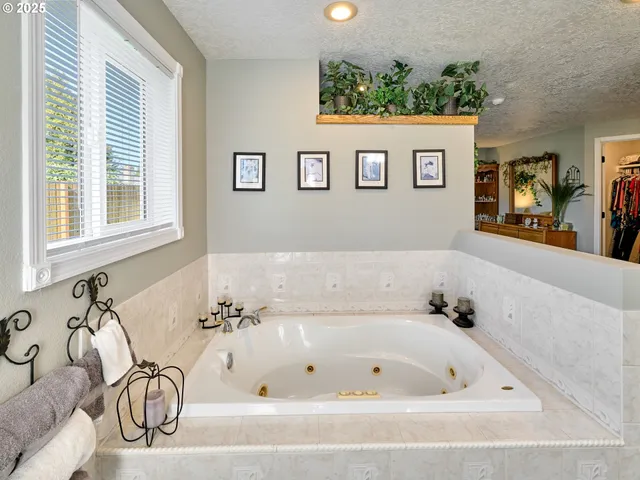 a bathroom with a bathtub and a window
