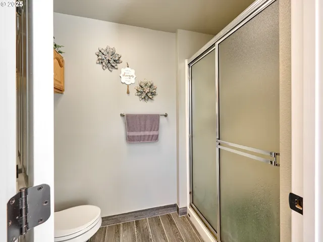 a bathroom with a shower toilet and sink