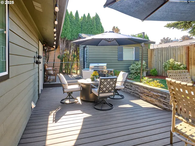 a view of a patio with table and chairs