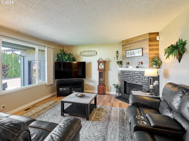 a living room with furniture a flat screen tv and a fireplace