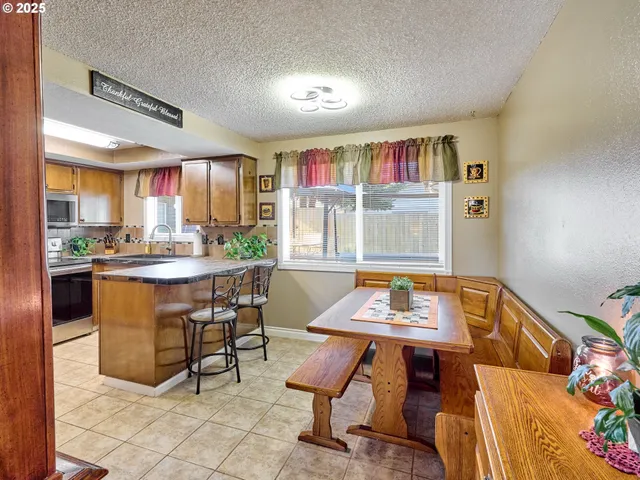 a dining room with a table and chairs