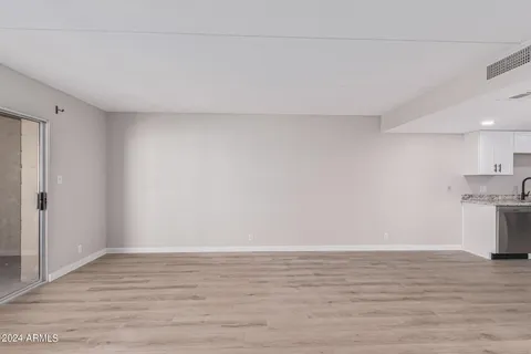 a view of a room with wooden floor and cabinet