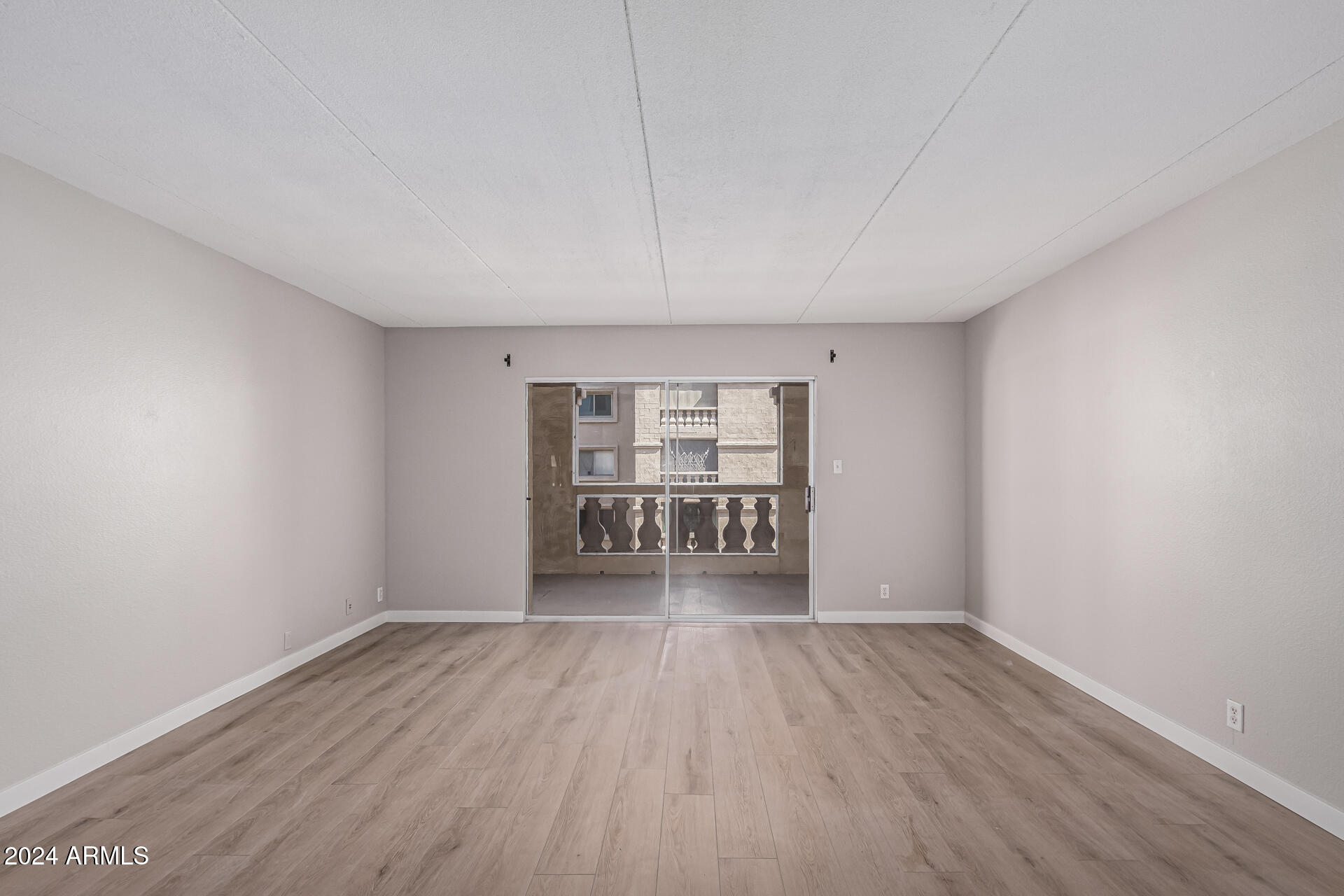 7930 East Camelback Road, Unit 506 Scottsdale, AZ 85251 - Photo 12 of 58 wooden floor in an empty room with a window